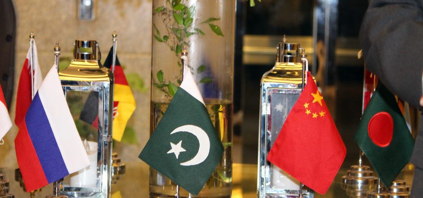 Table set with the flags of several nations at the dinner hosted for the Australian delegation in Karachi